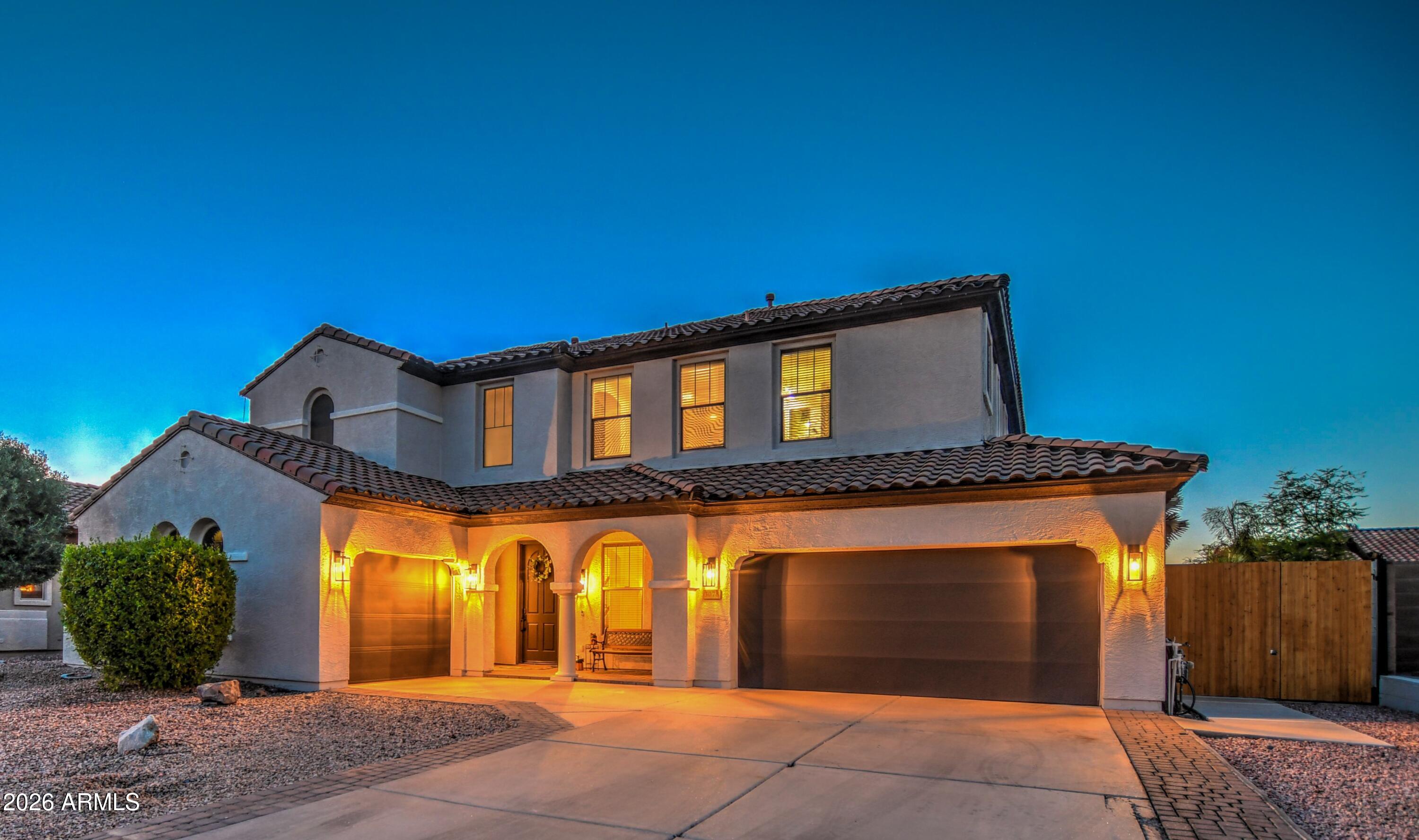 3078 East Muirfield Street Gilbert, AZ 85298 - Photo 4 of 92 a front view of a house with plants
