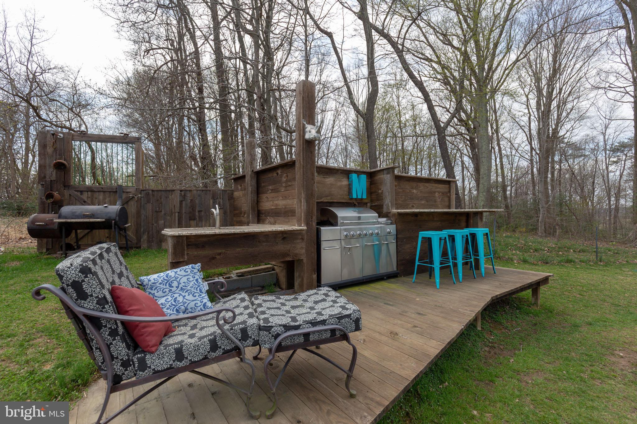 8130 Bourne Road Owings, MD 20736 - Photo 32 of 41 Outdoor Kitchen and Seating Area