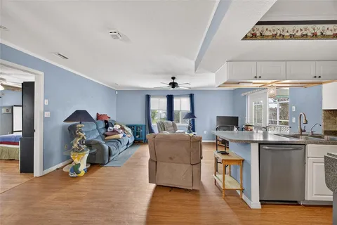 a living room with furniture and a chandelier