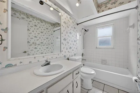 a bathroom with a sink toilet tub and shower