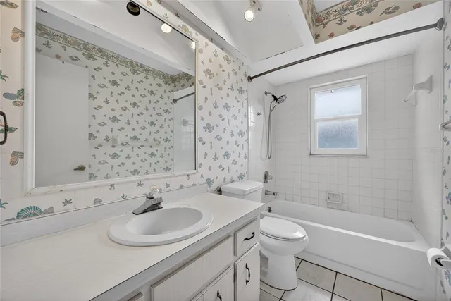 a bathroom with a sink toilet tub and shower