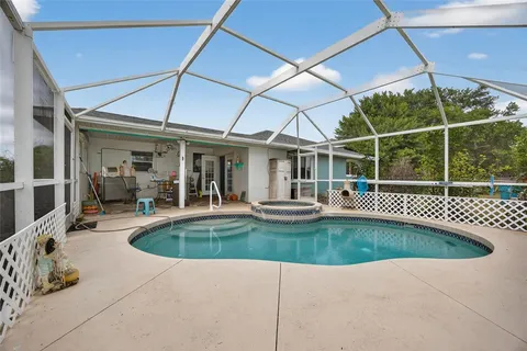 a view of a house with swimming pool and porch
