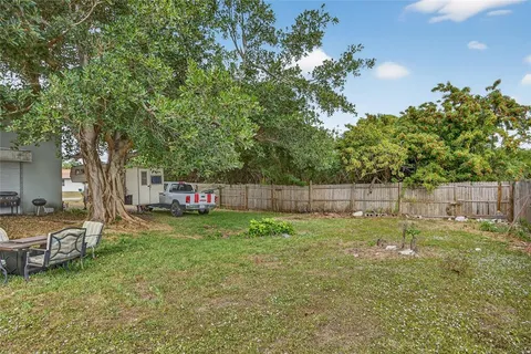 a view of a backyard with a tree