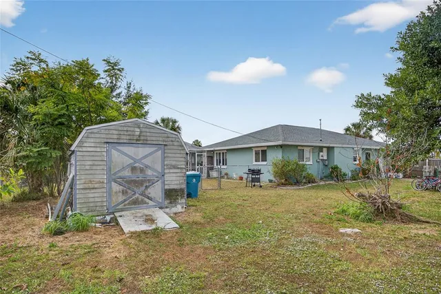 a view of a house with a yard and a garden
