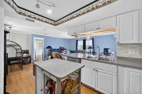 a kitchen with a stove a refrigerator and a sink