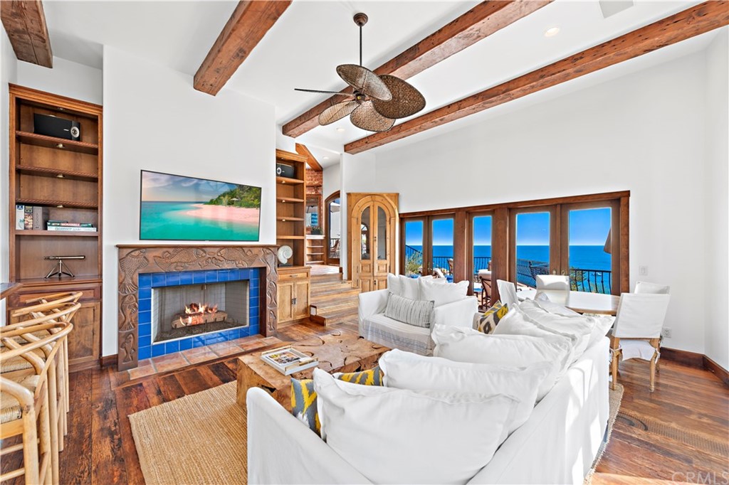 111 Emerald Bay Laguna Beach, CA 92651 - Photo 16 of 60 a living room with furniture a fireplace and a flat screen tv
