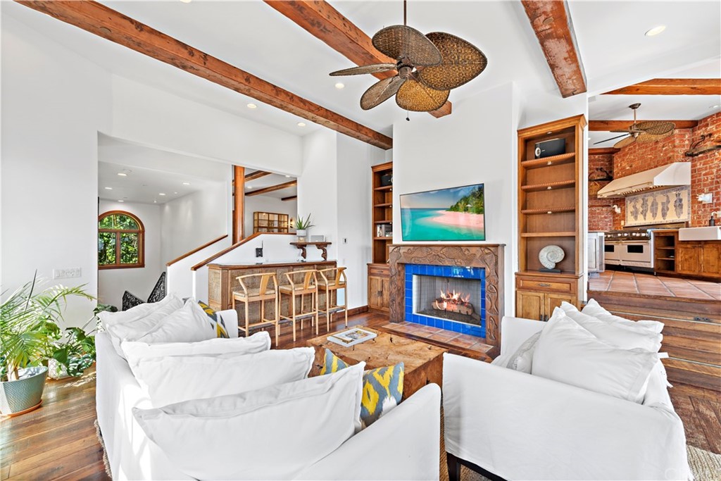 111 Emerald Bay Laguna Beach, CA 92651 - Photo 18 of 60 a living room with furniture a fireplace and a chandelier