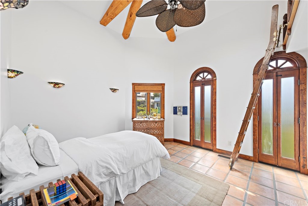 111 Emerald Bay Laguna Beach, CA 92651 - Photo 37 of 60 a bedroom with a bed and dresser with mirror