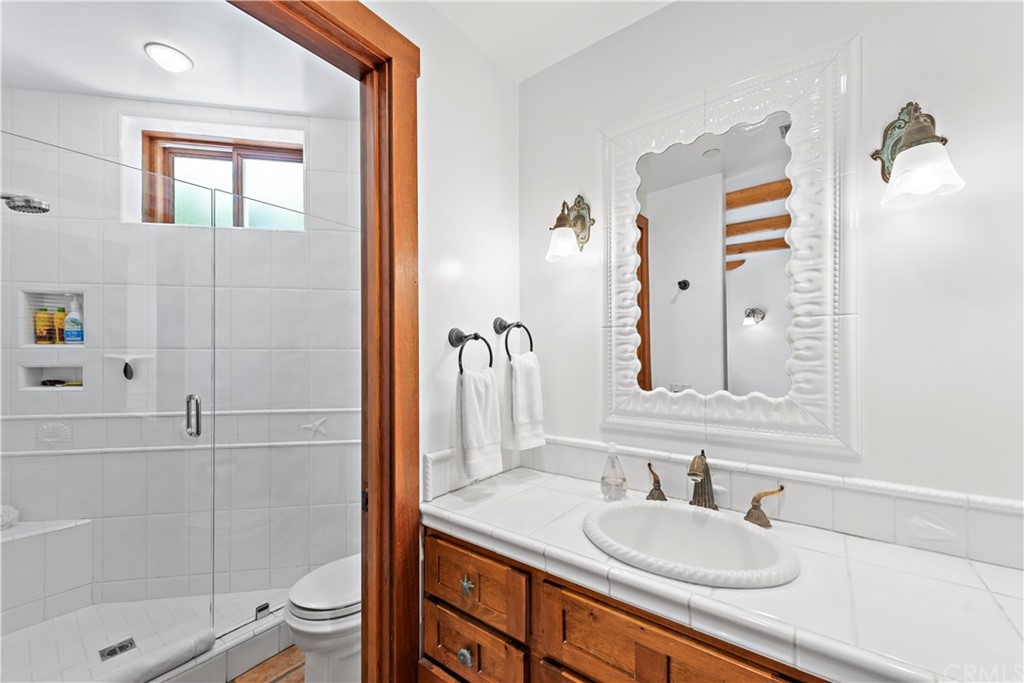 111 Emerald Bay Laguna Beach, CA 92651 - Photo 40 of 60 a bathroom with a granite countertop sink toilet and shower