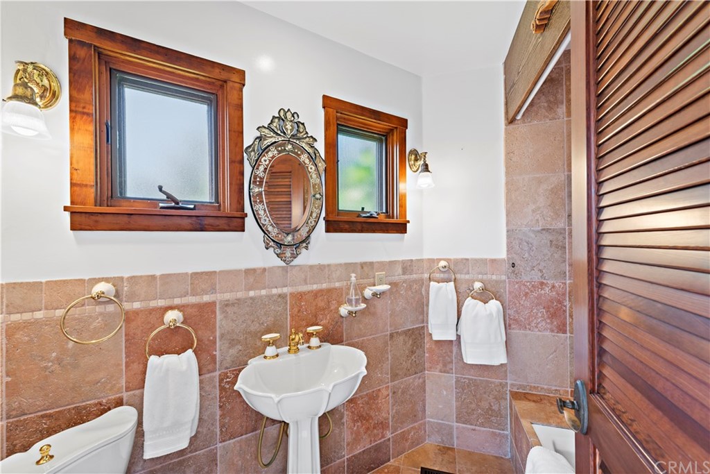 111 Emerald Bay Laguna Beach, CA 92651 - Photo 8 of 60 a bathroom with a sink and a mirror