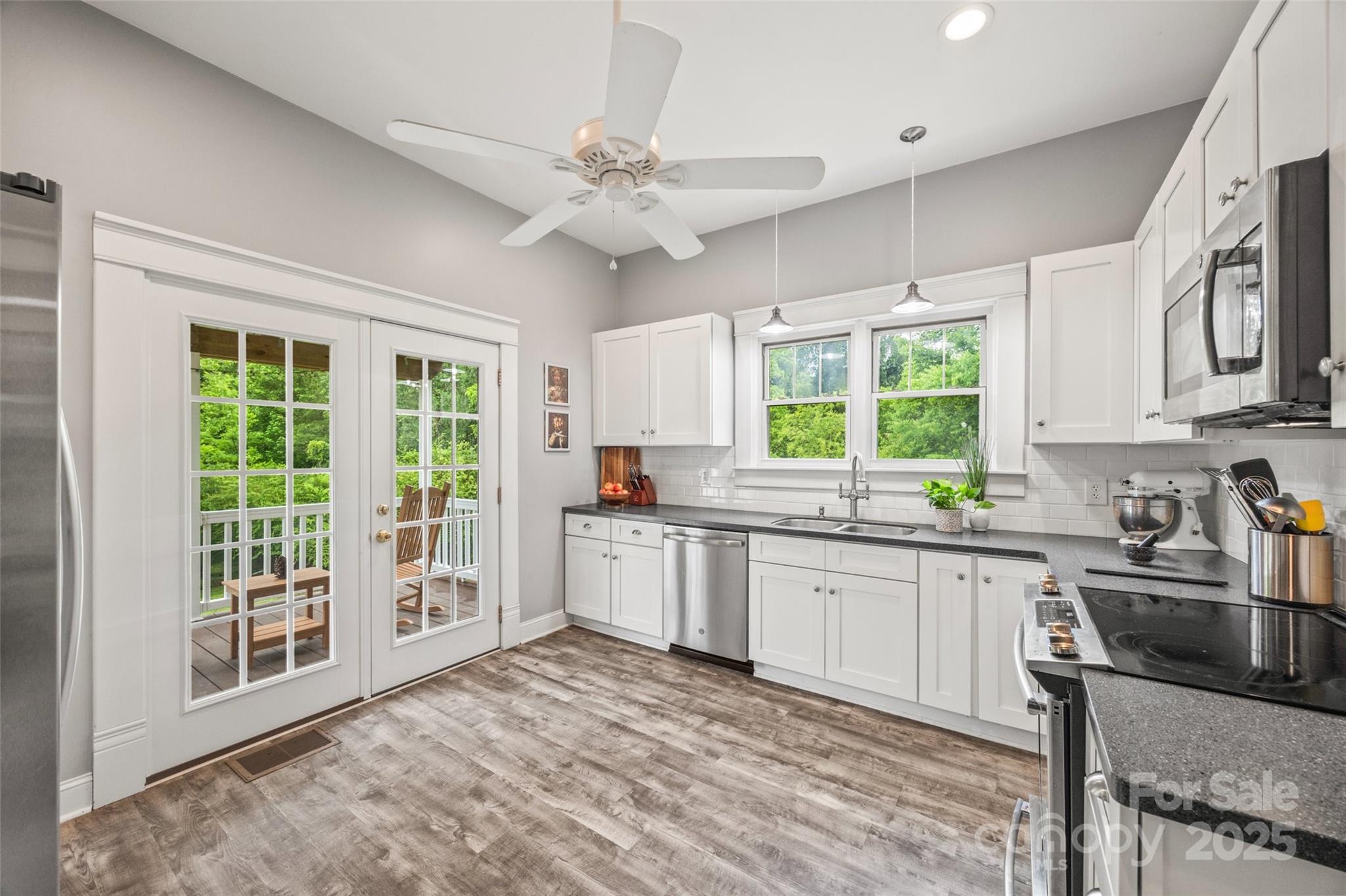 4569 Edgeland Road Edgemoor, SC 29712 - Photo 11 of 44 a kitchen with stainless steel appliances granite countertop a stove top oven a sink a dining table and chairs
