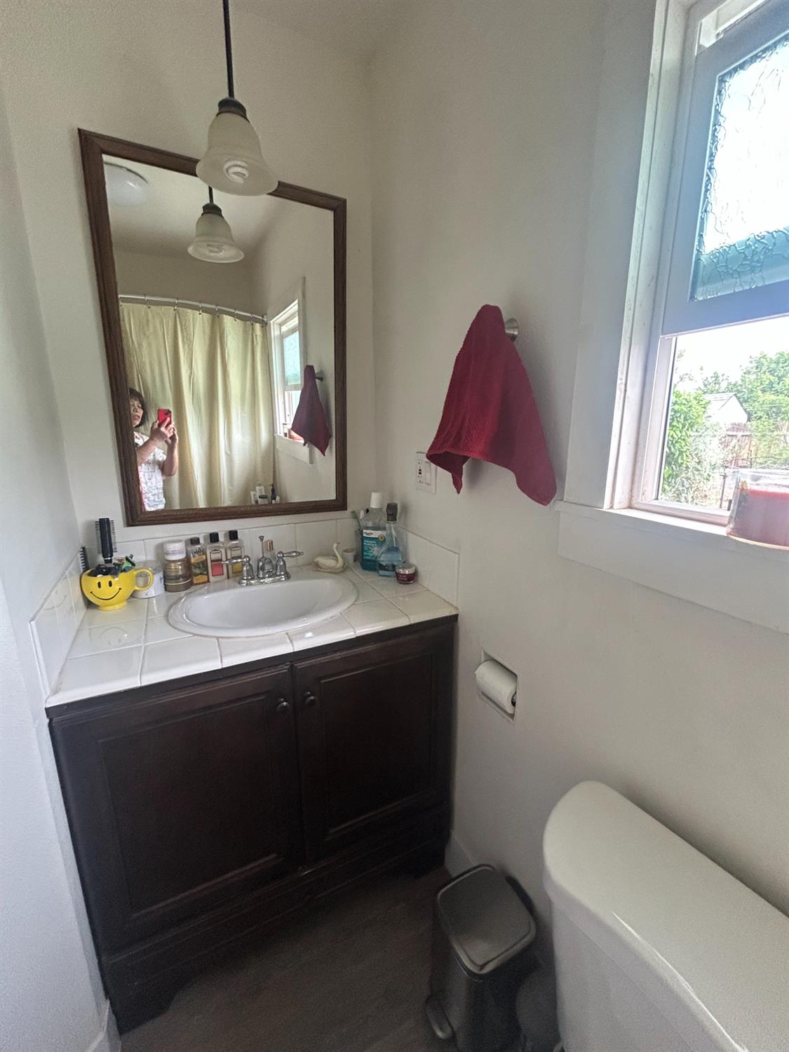 313 East Sacramento Street Coalinga, CA 93210 - Photo 10 of 23 a bathroom with a toilet sink and mirror