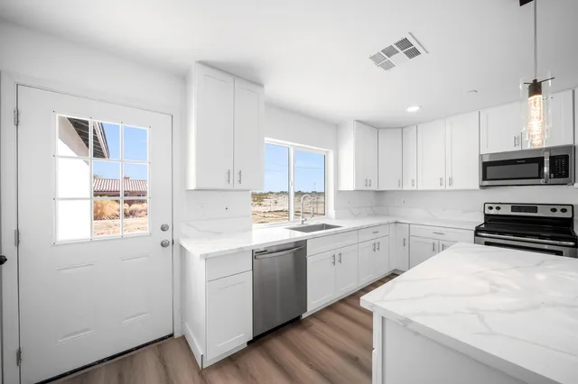 a kitchen with a sink stainless steel appliances and cabinets
