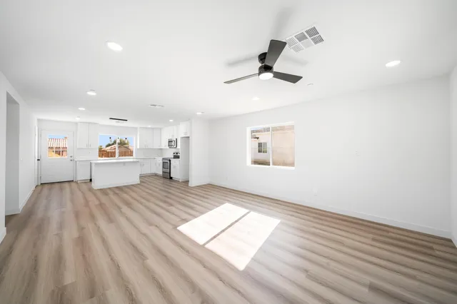 a view of kitchen with a sink wooden floor and windows