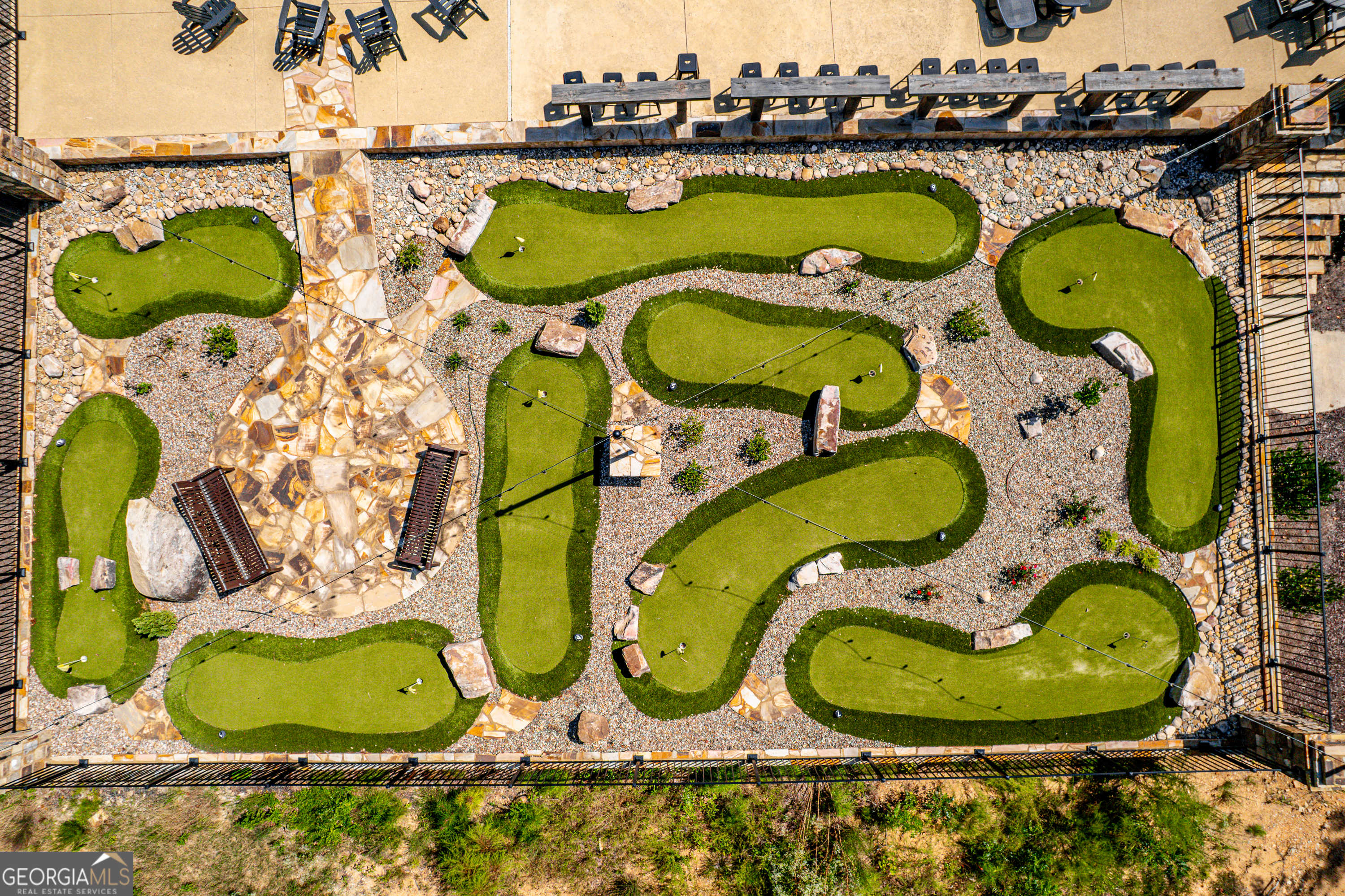 302 Wind Rock Ridge Northeast Milledgeville, GA 31061 - Photo 11 of 24 an aerial view of a swimming pool with outdoor seating and yard
