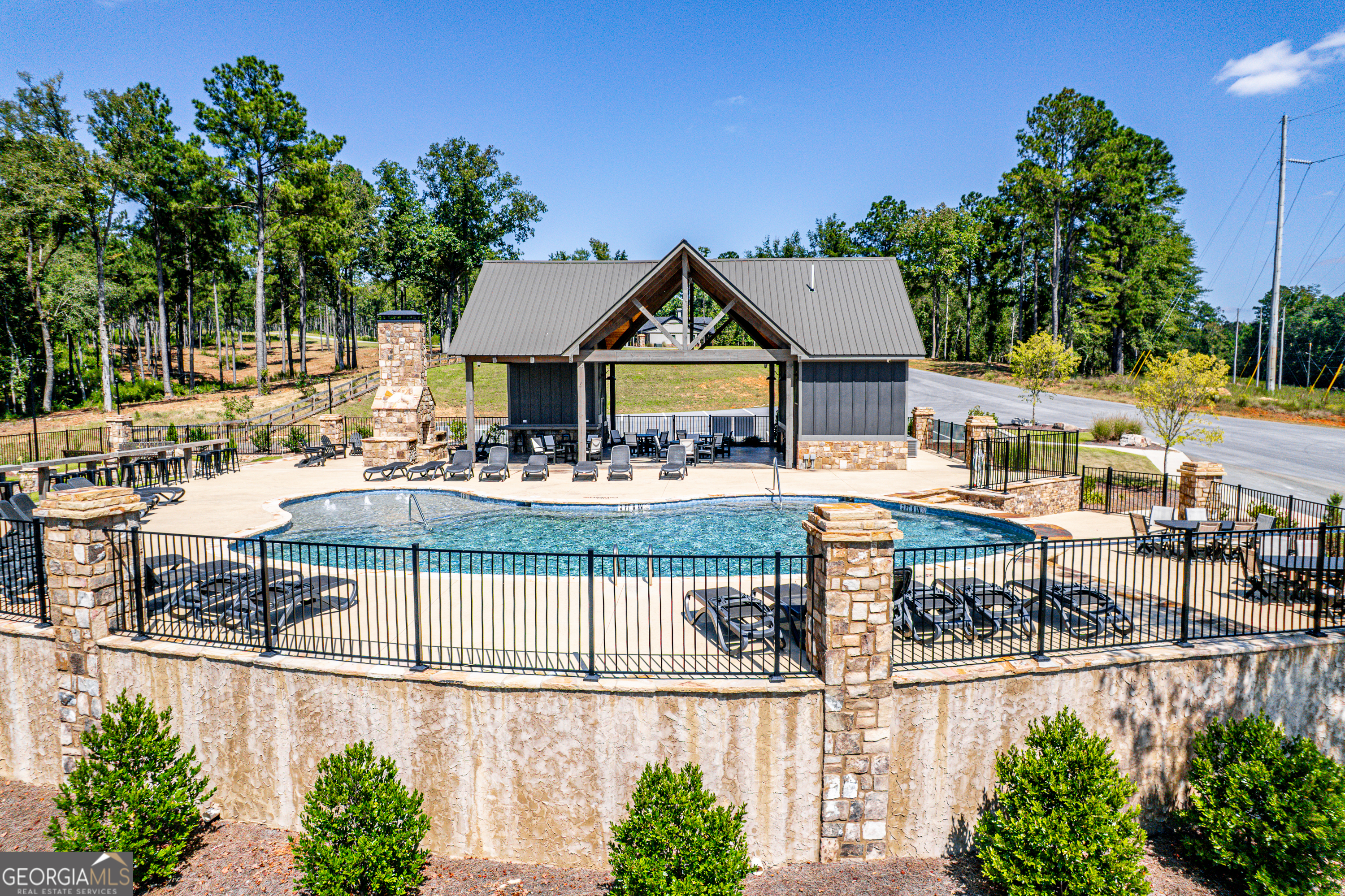 302 Wind Rock Ridge Northeast Milledgeville, GA 31061 - Photo 13 of 24 a view of a building with a garden and sitting area
