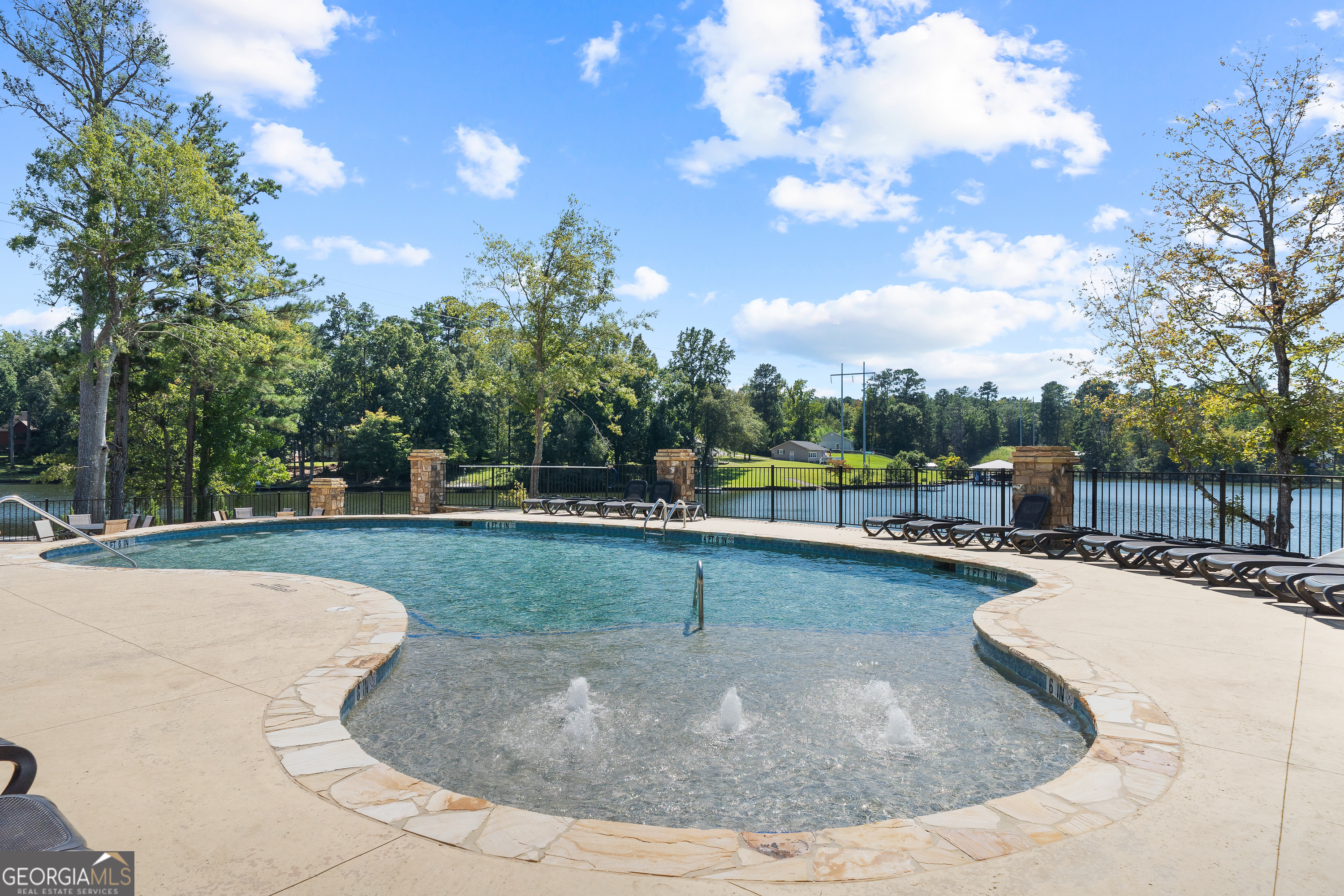 302 Wind Rock Ridge Northeast Milledgeville, GA 31061 - Photo 22 of 24 a view of a swimming pool with a yard
