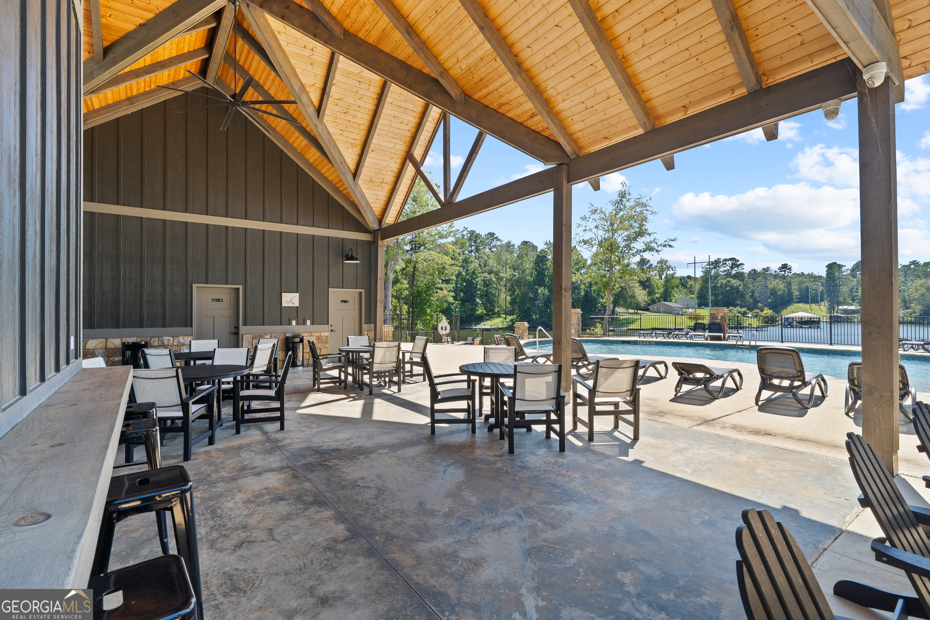 302 Wind Rock Ridge Northeast Milledgeville, GA 31061 - Photo 23 of 24 a view of a patio with a table chairs and a patio