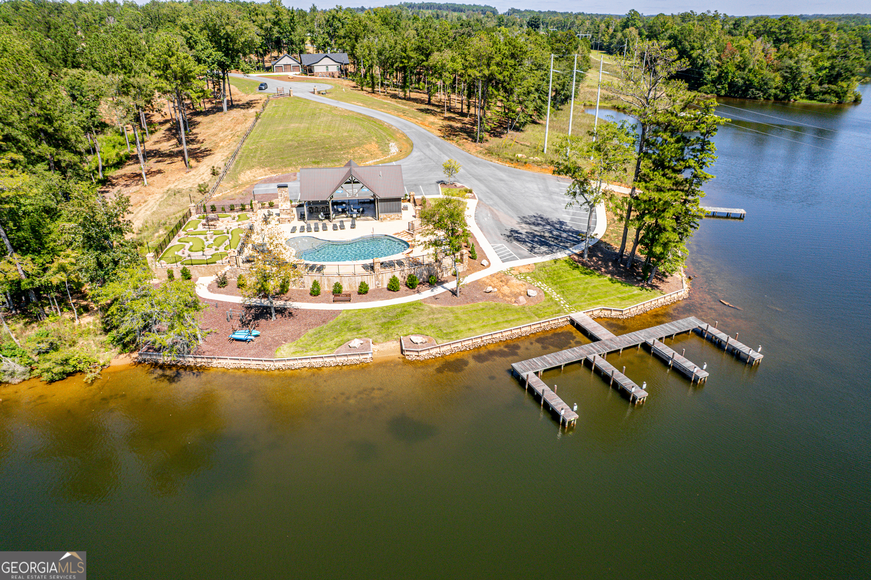 302 Wind Rock Ridge Northeast Milledgeville, GA 31061 - Photo 7 of 24 a view of a swimming pool with wooden floor and lake view