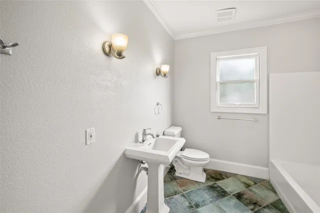 a bathroom with a sink toilet and a mirror