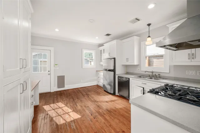 a kitchen with a sink stove and refrigerator