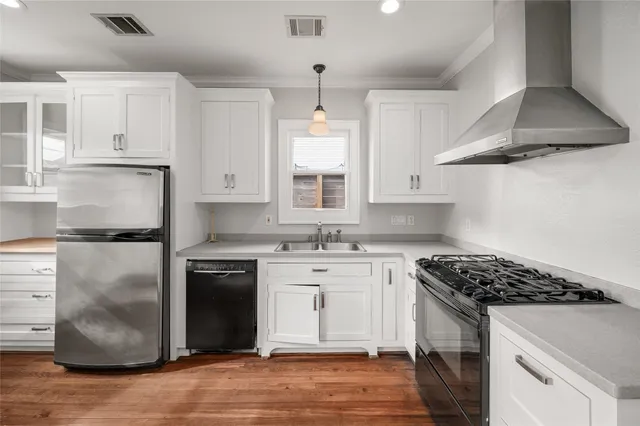 a kitchen with stainless steel appliances granite countertop a stove a refrigerator and a sink