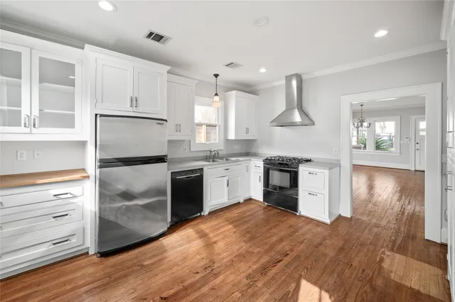 a kitchen with white cabinets and stainless steel appliances