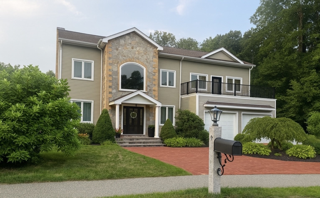 a front view of a house with a yard and potted plants
