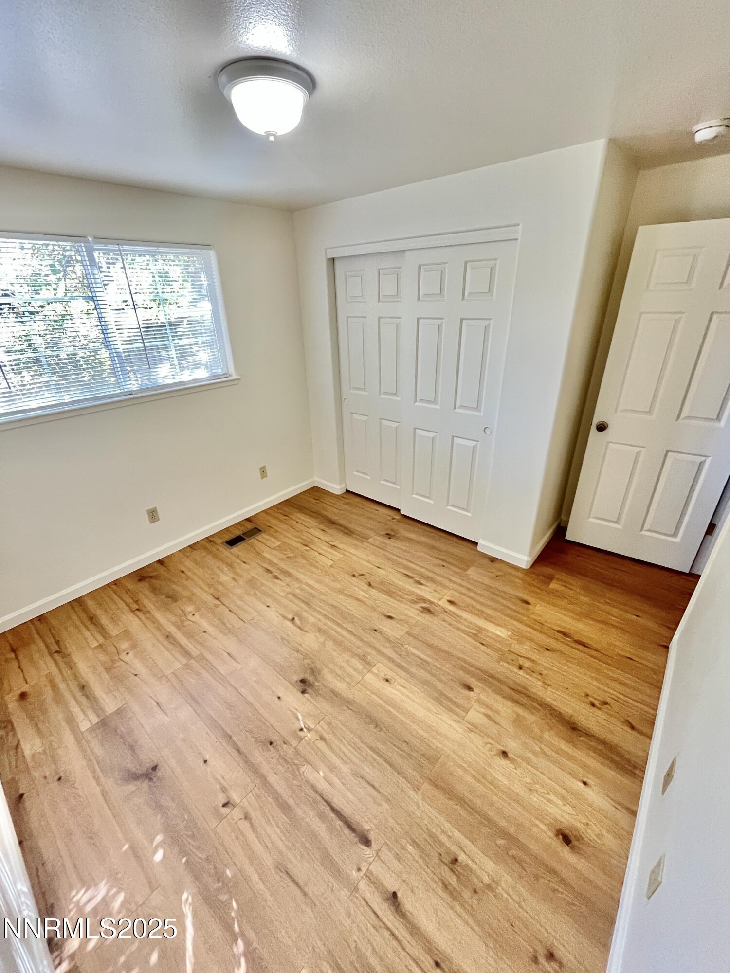 1501 Gault Way Sparks, NV 89431 - Photo 12 of 18 a view of empty room with wooden floor and fan