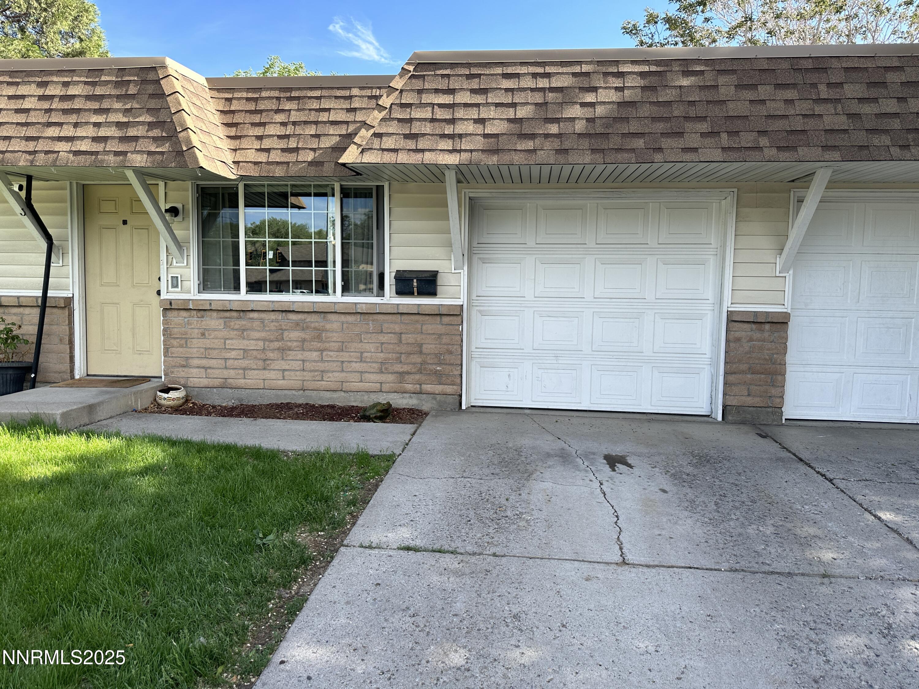 1501 Gault Way Sparks, NV 89431 - Photo 2 of 18 a front view of a house with a garden