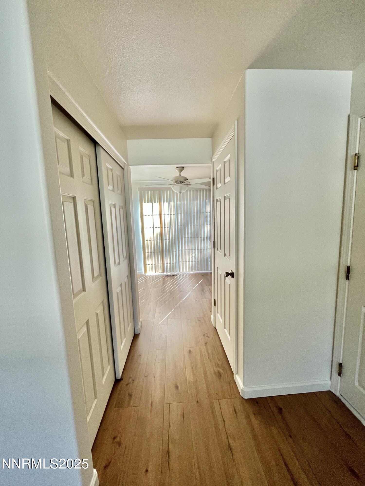 1501 Gault Way Sparks, NV 89431 - Photo 8 of 18 a view of a hallway with wooden floor and staircase