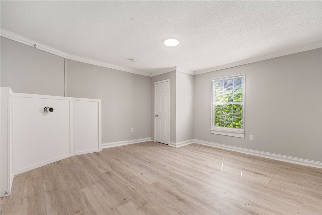109 Farmer Street Anderson, SC 29621 - Photo 28 of 31 A window-filled room with light-toned flooring, perfect for a versatile living space.
