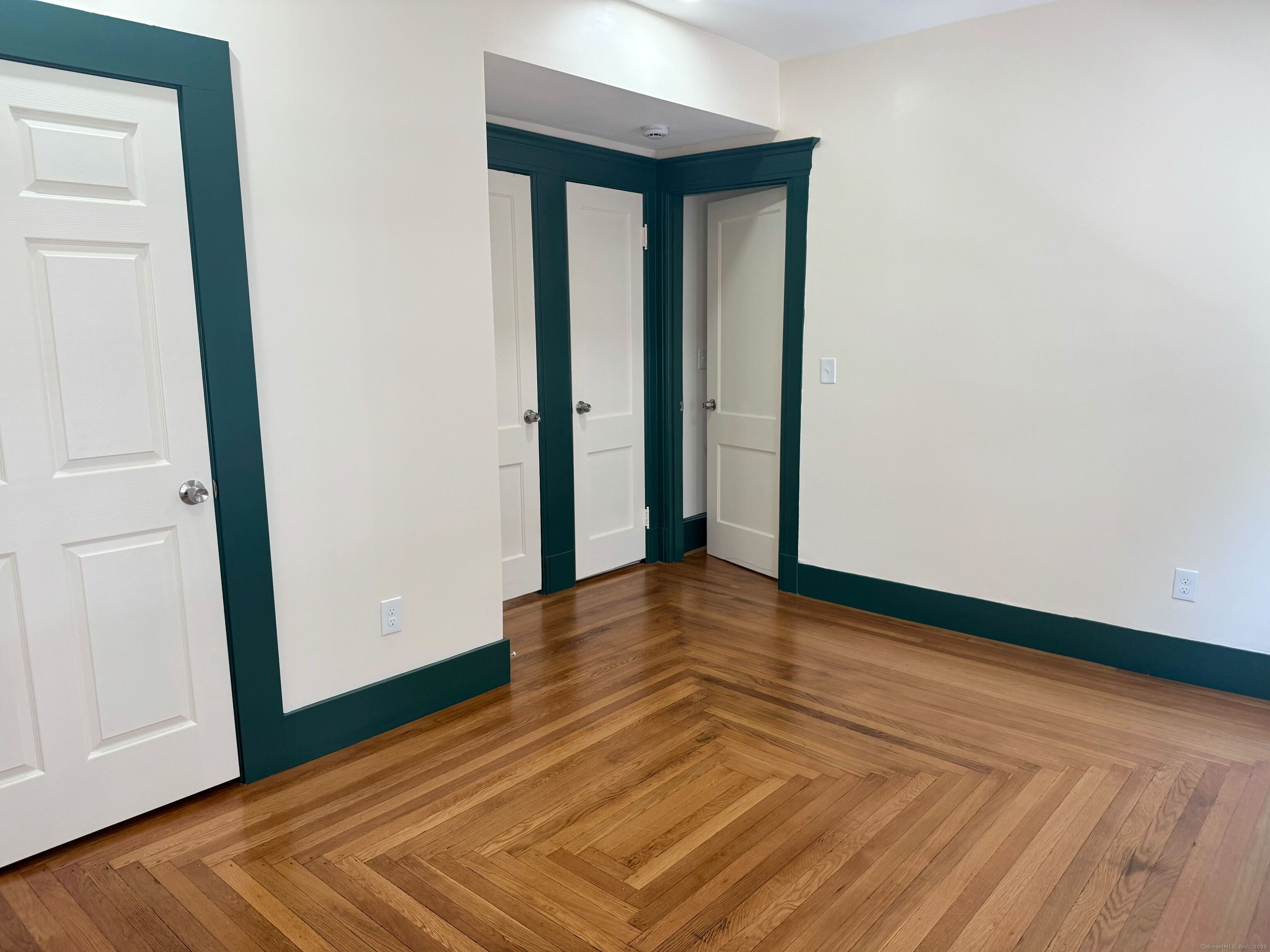 130 Hubinger Street, Unit 2 New Haven, CT 06511 - Photo 4 of 12 a view of empty room with wooden floor and fan