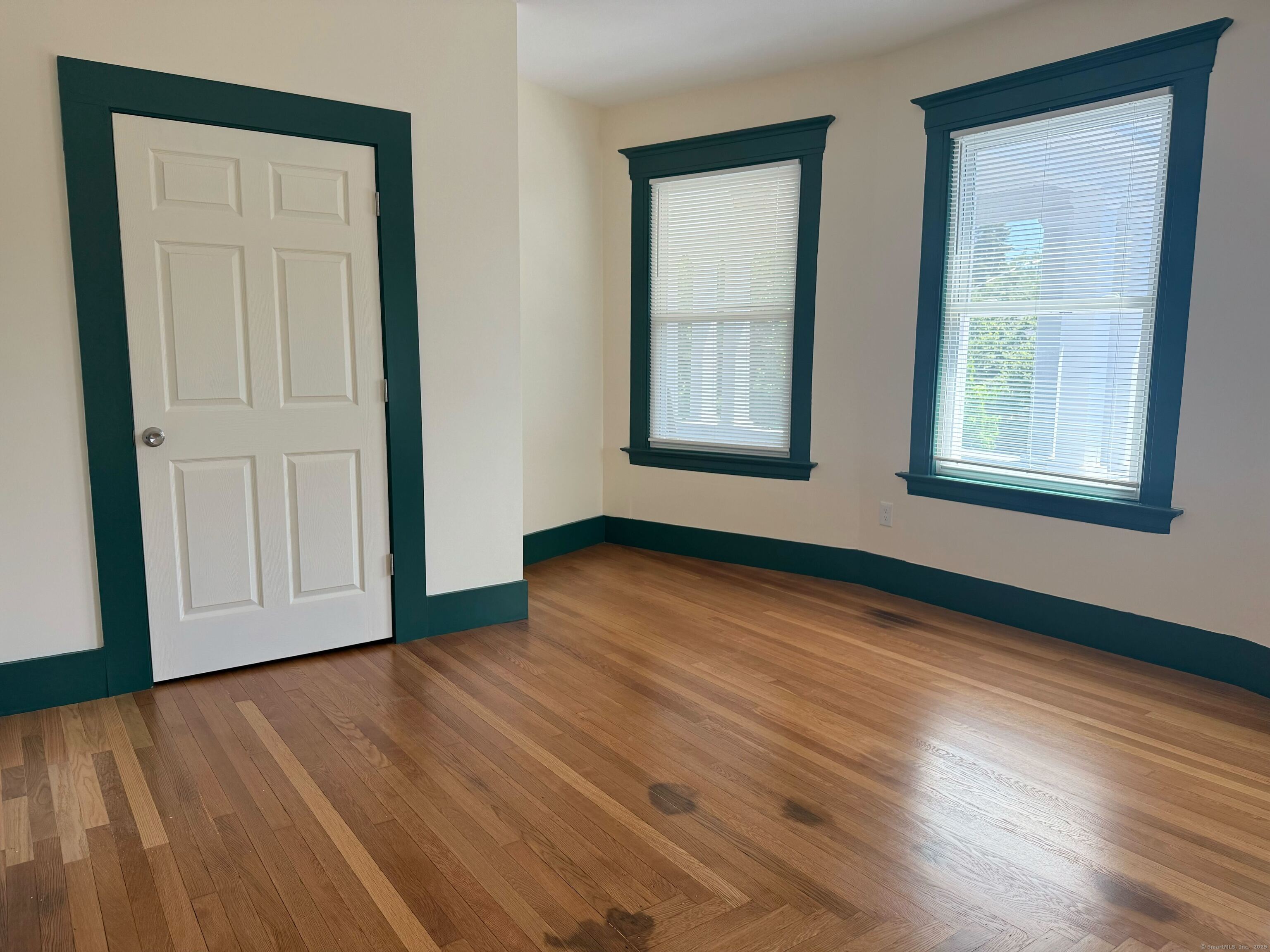 130 Hubinger Street, Unit 2 New Haven, CT 06511 - Photo 5 of 12 an empty room with wooden floor and windows