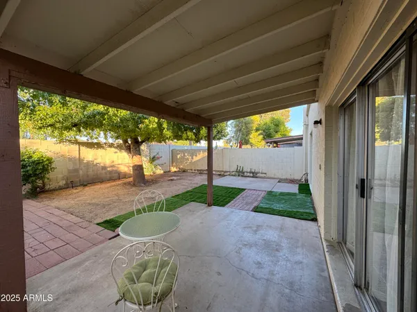 a view of a house with backyard and a tree