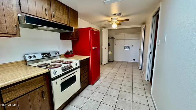 a kitchen with granite countertop a stove a sink and dishwasher