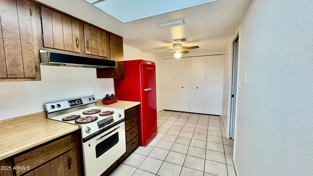 a kitchen with stainless steel appliances granite countertop a stove a sink and cabinets