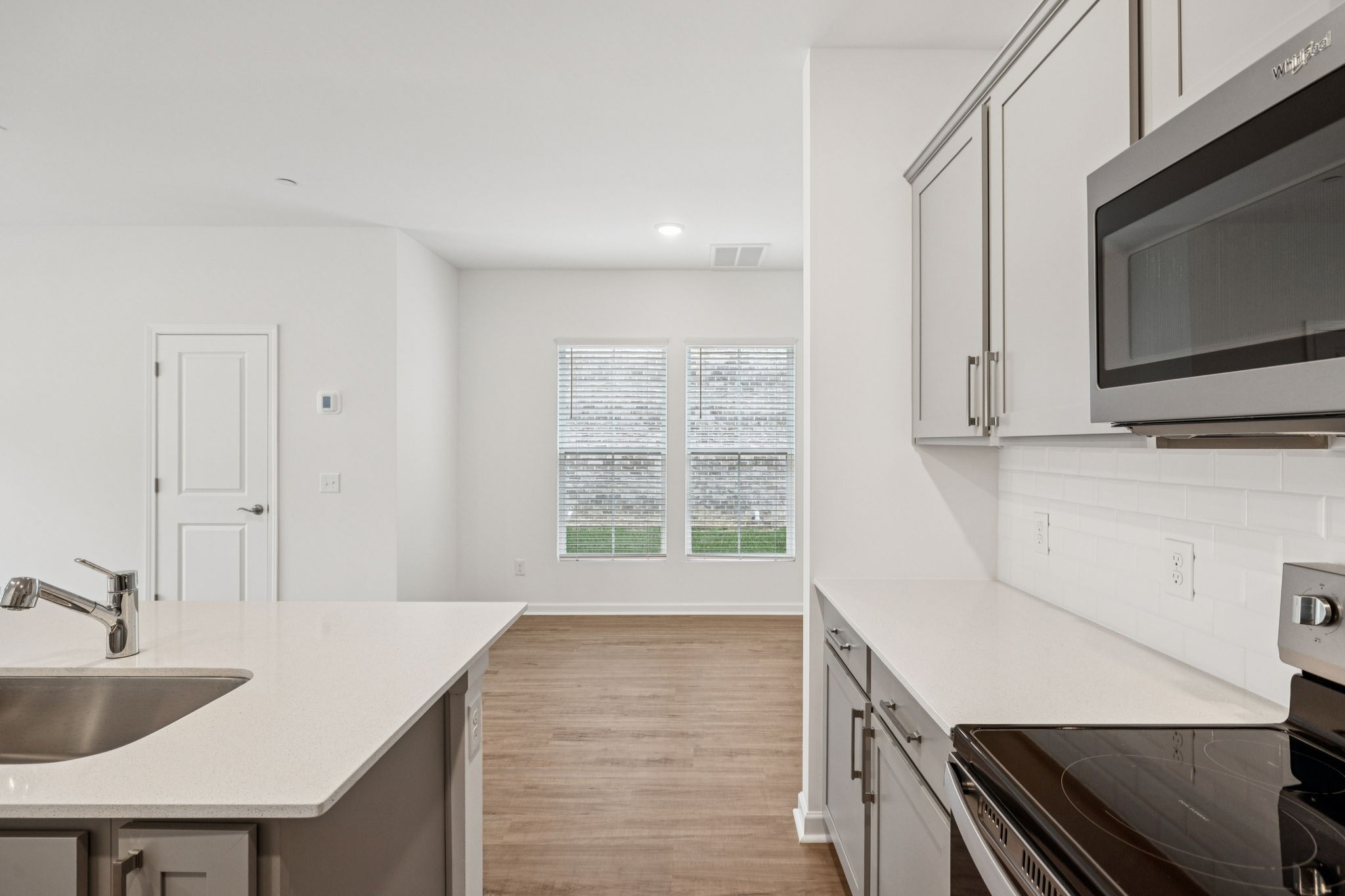 7148 Mapleside Lane Fairview, TN 37062 - Photo 11 of 39 a kitchen with a sink a microwave and cabinets