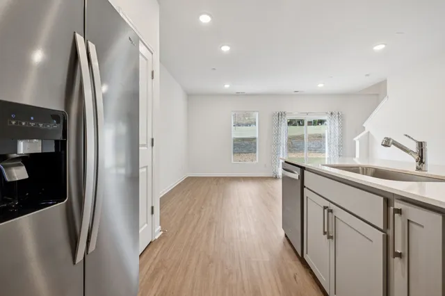a kitchen with stainless steel appliances a refrigerator and a sink