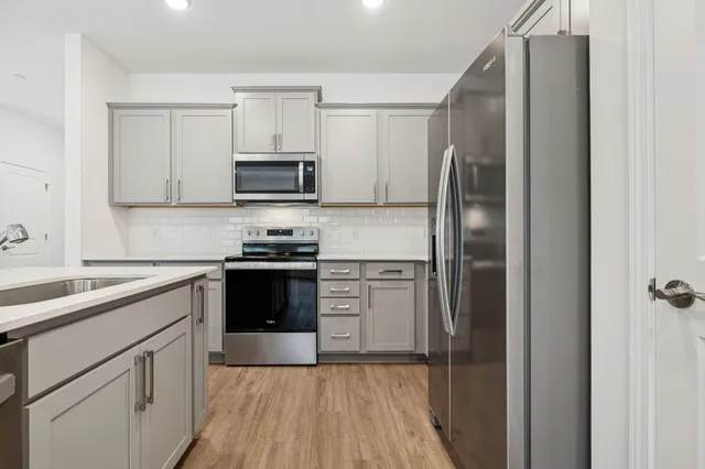 a kitchen with a refrigerator stove and microwave