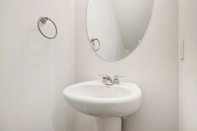 a bathroom with a mirror and a sink