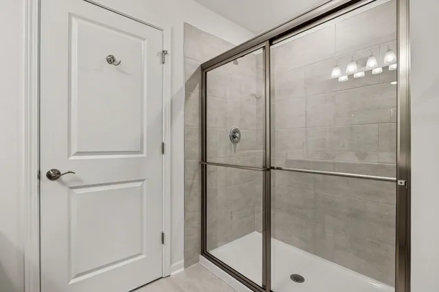 a bathroom with a glass shower door