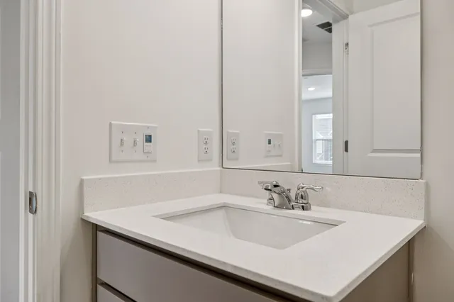 a bathroom with a sink vanity and a mirror