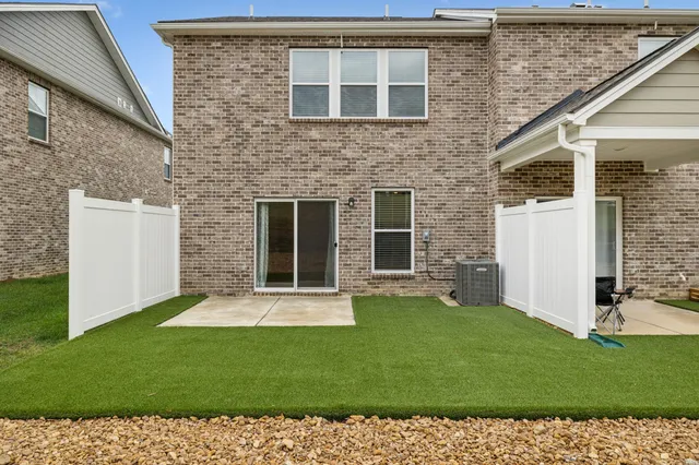 a view of a house with a yard and a garden
