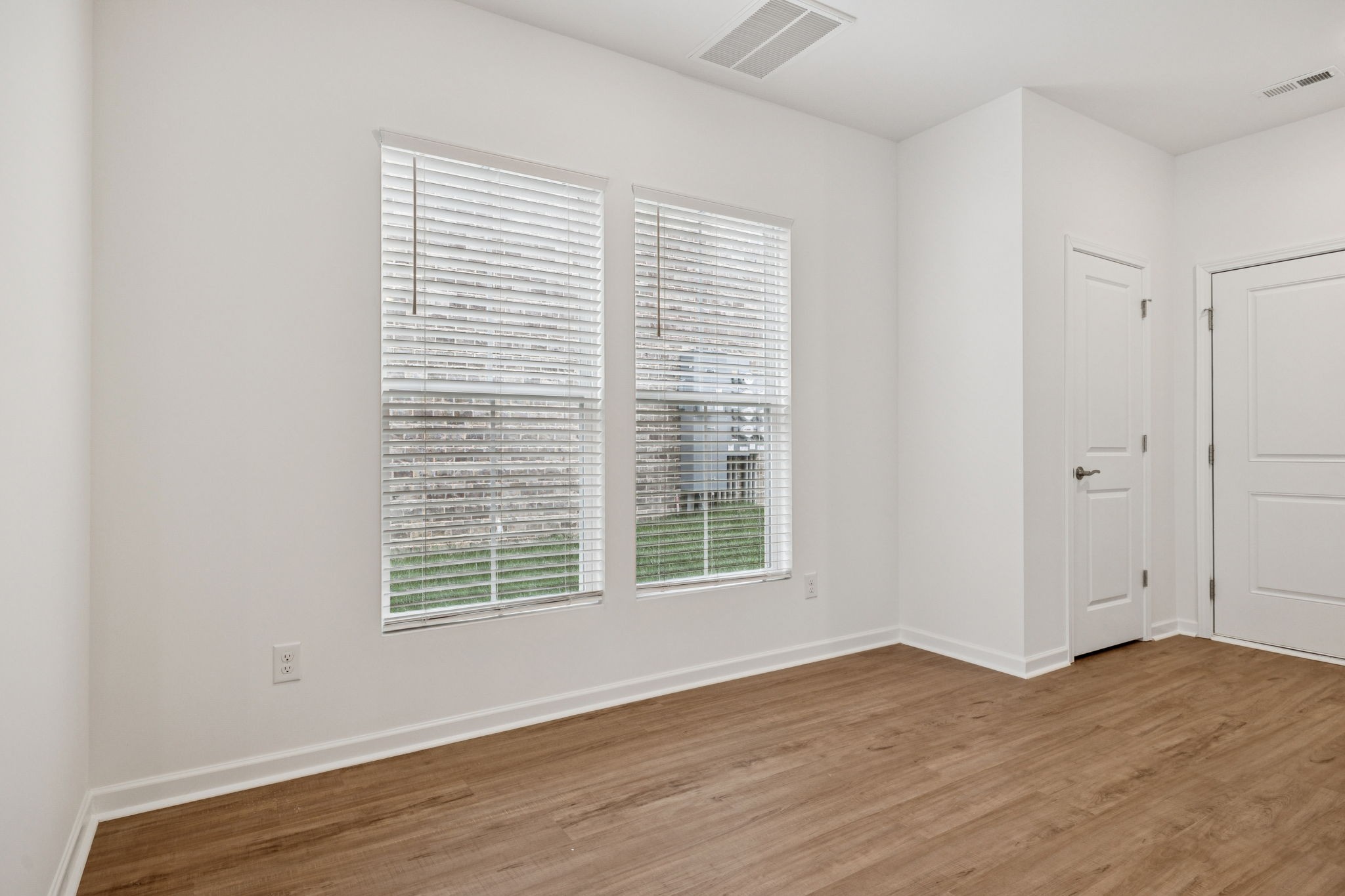 7148 Mapleside Lane Fairview, TN 37062 - Photo 6 of 39 a view of an empty room with wooden floor and a window
