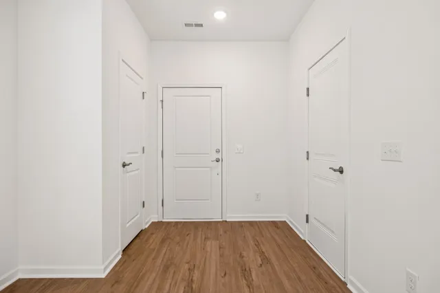 a view of a room with wooden floor