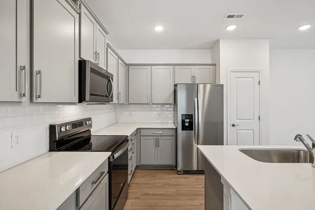 a kitchen with a sink a stove and refrigerator