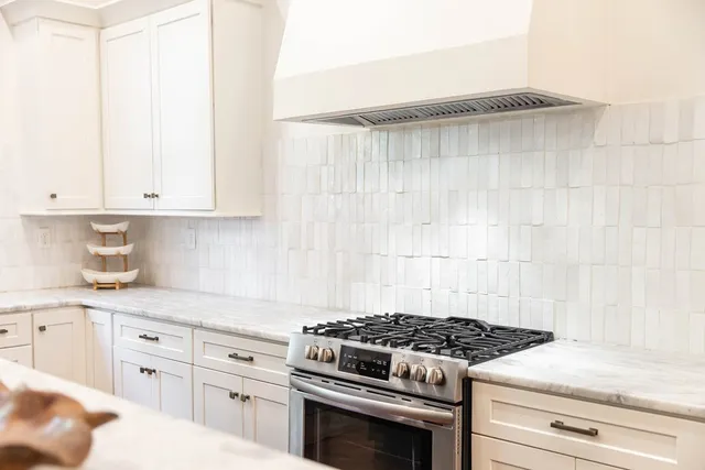 a view of staircase with lots of frames on wall and a dining room view