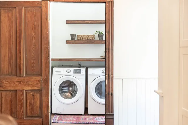 a view of a backyard with a slide trees and wooden fence