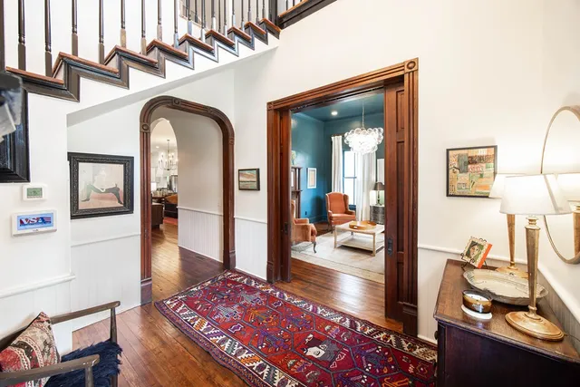 a living room with furniture a chandelier and a window